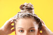 Leinwandbild Motiv Young woman washing hair on yellow background, closeup