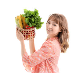 Wall Mural - Happy young female farmer with wicker basket full of different ripe vegetables isolated on white background