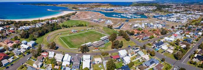 Wall Mural - Panoramic aerial drone view of Shellharbour looking over Shellharbour South Beach and Shellharbour Marina on the New South Wales South Coast, Australia on a sunny day 