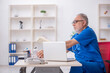 © Elnur - Old male doctor working in the clinic
