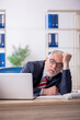 © Elnur - Old male employee and too much work in the office
