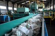 Conveyor belt with plastic recyclables on it in a facility, Waste management concept.