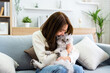 Portrait of young Asian woman holding cute cat. Female hugging her cute long hair kitty. Adorable pet concept