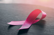 pink ribbon placed on wood table , world cancer day, healthcare and medicine backdrop, suicide prevention, children health care.