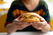 Close up hand holding hamburger