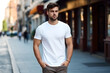 © AspctStyle - Young bearded man dressed in white t-shirt stands on city street. Mock up. Space for logo, text, image