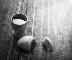 A bowl of wine and bread on the table. Communion symbols