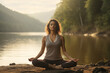 © frimufilms - A woman meditating on the shore of a lake