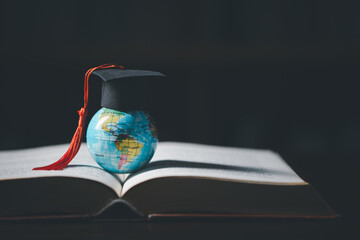 Graduated study abroad international Conceptual, Graduation hat on top Earth globe model map.Congratulations to graduates, Studies lead to success in world wide.Back to School. credited world by NASA