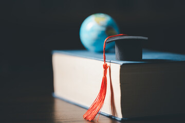 Wall Mural - Graduated study abroad international Conceptual, Graduation hat on top Earth globe model map.Congratulations to graduates, Studies lead to success in world wide.Back to School. credited world by NASA