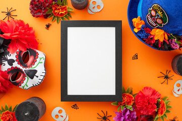 Join the festive spectacle Dia de los Muertos. Top view photo of carnival mask, traditional hat, flowers, candles, spooky decor on orange background with empty frame for promo or text