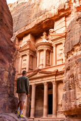 Rear view of man in spectacular view of Al Khazneh (The Treasury), ancient city of Petra, Jordan