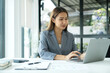 © Orathai - Asian businesswoman sit at their desks and calculate financial graphs showing results about their investments, planning a successful business growth process