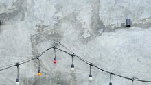 Christmas Lights Hanging On The Concrete Wall, With Copy Space For Text