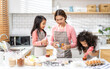 © Art_Photo - Portrait of enjoy happy love asian family mother and little toddler asian girl daughter child having fun cooking together with dough for homemade bake cookie and cake ingredient on table in kitchen