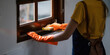 Housekeeper cleaning window sill with orange rag cleaning service. housekeeping advertising concept