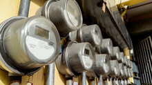 Several Digital Electric Meters Installed On The Wall At An Apartment Building Or Other Commercial Property.