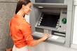 © Prostock-studio - Bank Client Woman Using ATM Machine For Money Withdrawal Outdoor