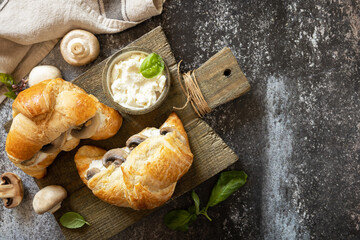 Sticker - French pastry, tasty freshly baked sandwich. Vegan food style. Croissant with cream cheese and mushroom on a stone background.  View from above. Copy space.