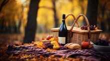 Cozy Autumn Picnic In The Sunny Fall Park. Basket With Wine Bottle, Apple, Grape And Bread On Picnic Plaid On Nature Yellow Trees Background. Autumn Active Lifestyle