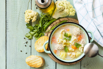 Sticker - Low carb healthy eating. Cauliflower soup with chicken meatballs and vegetables on a wooden rustic table. View from above. Copy space.