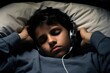 teenaged, Hispanic boy sprawled across bed, headphones in ears, eyes staring at ceiling lost in thought. Hes entranced by discussions on podcast hosted by famed psychiatrist specializing in