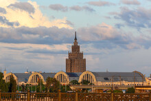 Central Market And Academy Of Sciences In Riga In Summer At Sunset, View Across The Daugava River