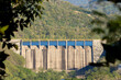 Honduran dam that is full of water and illuminated by harsh sunlight