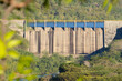 Honduran dam that is full of water and illuminated by harsh sunlight