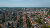 Fototapeta Miasto - Drone footage of historical Dutch city Gouda. aerial image of Netherlands urban skyline with houses, church and streets