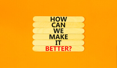 We make it better symbol. Concept words How can we make it better on wooden stick. Beautiful orange table orange background. Business we make it better concept. Copy space.