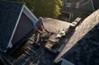 Top-down view of asphalt shingles being installed on a roof by a roofer. Generative AI