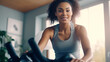 © LomaPari2021 - photograph of Happy cute african american woman cycling for exercise and wellness at home. Concept home gym.,generative ai