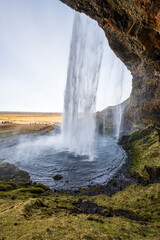 View of the unique Seljalandsfoss waterfall from the footpath that leads around the cave behind the waterfall, near Route 1 / Ring Road, Southern Region, Iceland