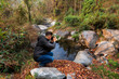 A male tourist takes photographs of a forest swamp in the region of Bidyang valley in Kalimpong district of India. 