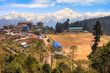 Beautiful aerial view of school and adjoining village town with view of the majestic Kanchenjunga Himalaya range at Kolakham in the district of Kalimpong, West Bengal, India