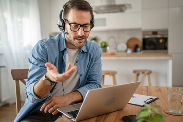 Wall Mural - One man caucasian male freelancer work from home on laptop computer