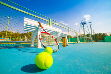 Wall Mural - Tennis racket and ball on the blue-coated court