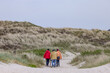 People walking on the sandy beach, Skalling at Blaavand huk,Denmark