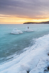 Wall Mural - Water slush in the sea. Sea winter landscape during sunset. Coast of the Japanese Sea.