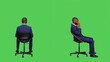 © DC Studio - Young businessman sitting on chair and waiting, wearing formal office suit and posing over full body greenscreen backdrop. Male startup employee feeling optimistic in studio, stylish worker.