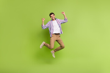 Aufkleber - Full size body photo of crazy active youngster man jumping raised fists up big discount promo shopping isolated on green color background