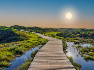 wooden walkway at slangkop lighthouse during sunset, kommetjie, cape town, south africa