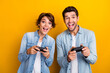 © deagreez - Photo of positive funky people family wear stylish denim clothes weekend together playstation competition isolated yellow color background