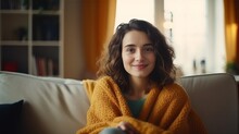 Happy Young Woman Sitting On Sofa At Home And Looking At Camera. Portrait Of Comfortable Woman In Winter Clothes Relaxing On Armchair. Portrait Of Beautiful Girl Smiling And Relaxing D : Generative AI