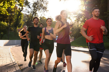 Sticker - Group of people running outdoors on sunny day