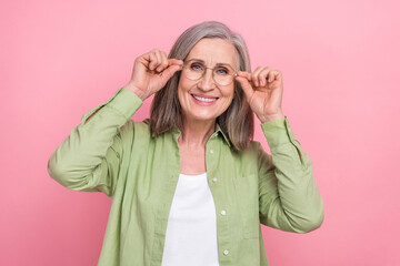 Sticker - Closeup portrait of attractive grandmother trying her new perfect eyeglasses goggles ophthalmology shop isolated on pink color background