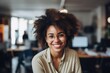 Smiling portrait of a happy young african american woman working for a modern startup company in a business ofice