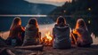a group of friends relaxing by a campfire during a lakeside picnic, their backs facing the camera. 