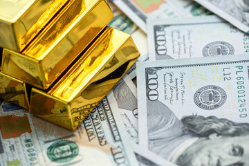 gold bars reflection on dollar bills background. The concept of finance wealth and rich